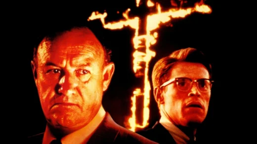 Gene Hackman e Willem Dafoe em Mississippi em Chamas com cruz em chamas ao fundo